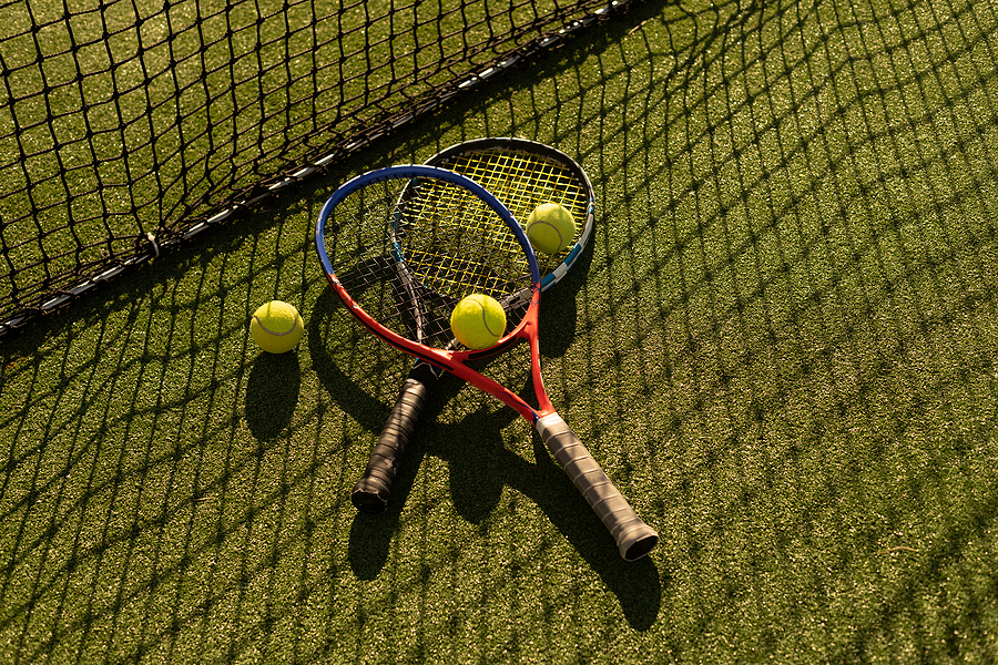 Tennis game. Tennis ball with racket on the tennis court. Sport, recreation concept.